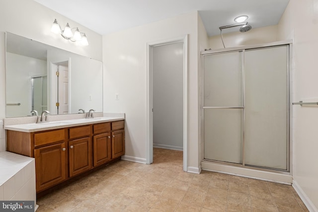 bathroom with vanity and a shower with door