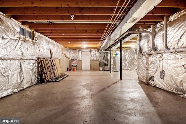 basement featuring gas water heater and heating unit