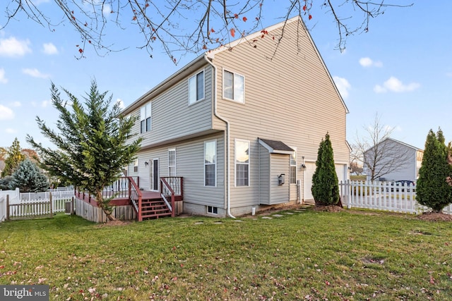 back of house with a wooden deck and a yard