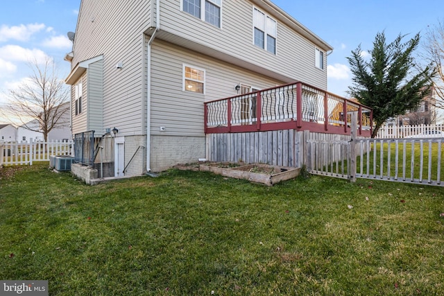 rear view of house with central air condition unit, a yard, and a deck