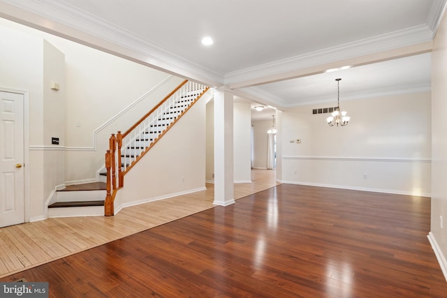 unfurnished living room with a chandelier, wood-type flooring, and crown molding