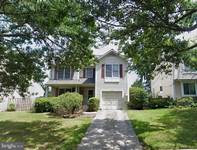 view of front of property with a front yard and a garage