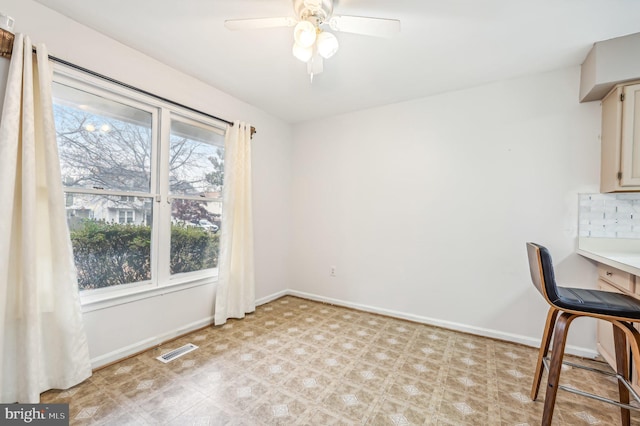 unfurnished office featuring ceiling fan