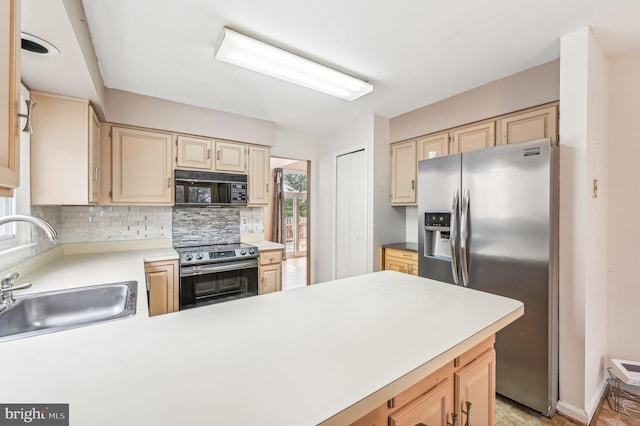 kitchen featuring backsplash, light brown cabinetry, sink, and stainless steel appliances