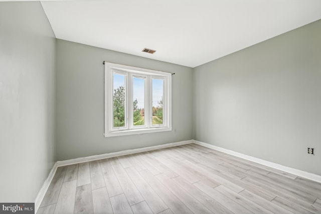 spare room featuring light wood-type flooring