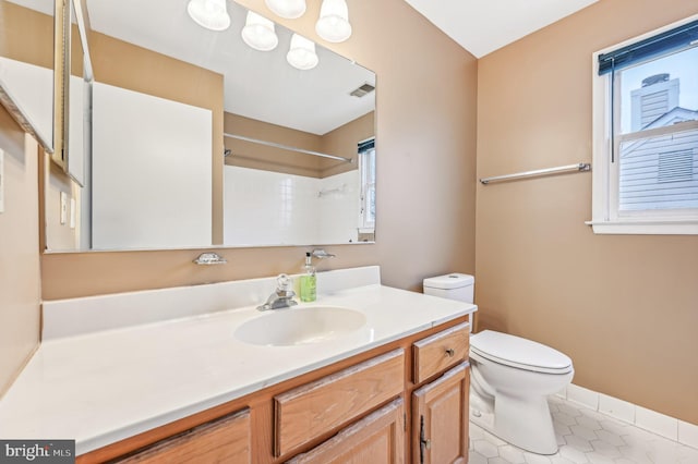 bathroom featuring walk in shower, tile patterned flooring, vanity, and toilet