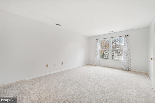 unfurnished room with light colored carpet