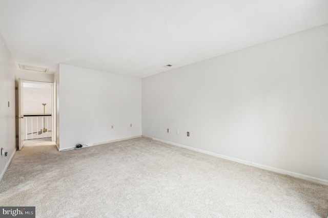 empty room featuring light carpet