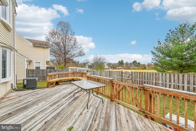 wooden terrace featuring cooling unit