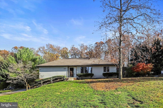 ranch-style home featuring a front yard