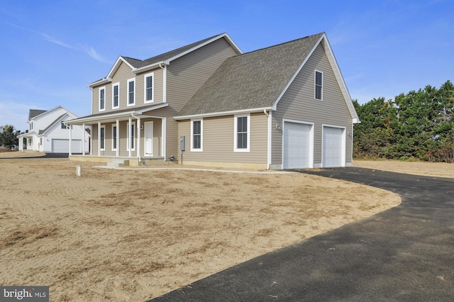 view of front of home with covered porch and a garage