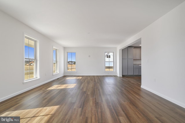 unfurnished living room featuring dark wood-type flooring