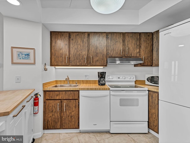 10900 Coastal Hwy Unit 915, Ocean City, MD 21842 - kitchen featuring white appliances, a sink, under cabinet range hood, light countertops, and light tile patterned floors