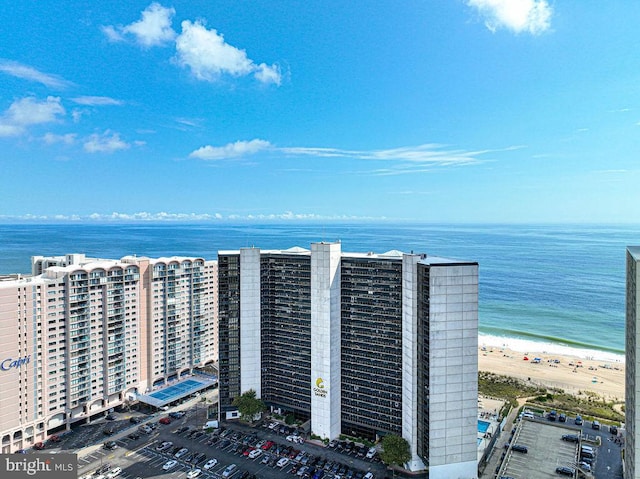 bird's eye view featuring a water view and a beach view