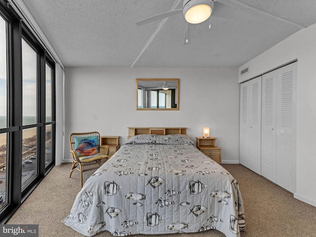 10900 Coastal Hwy Unit 915, Ocean City, MD 21842 - bedroom featuring carpet flooring, a textured ceiling, a closet, baseboards, and a ceiling fan