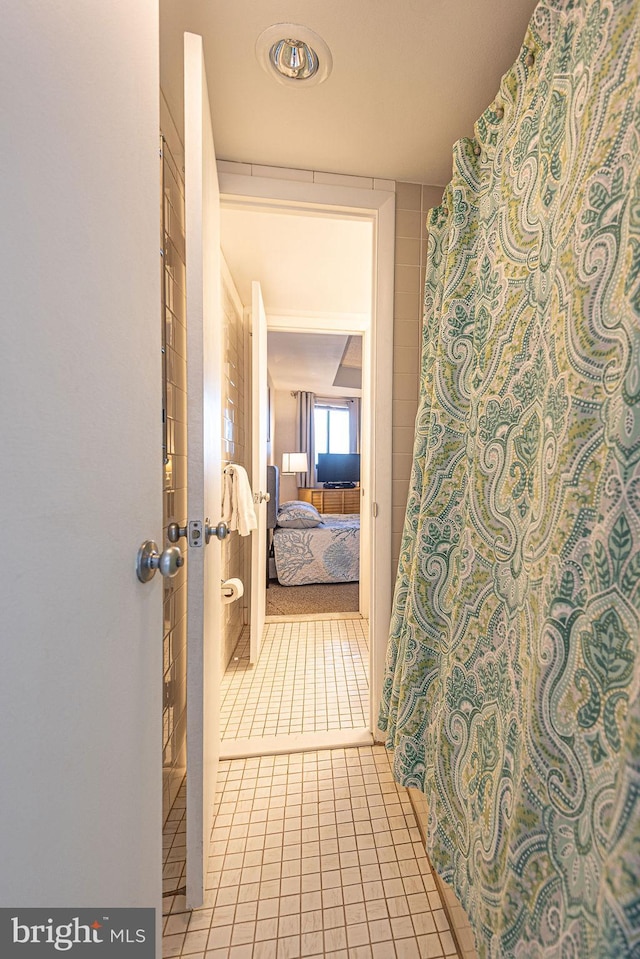 hall featuring light tile patterned floors