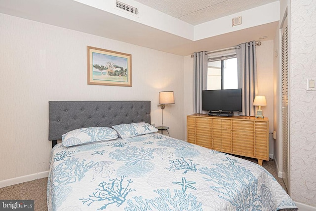 carpeted bedroom featuring a textured ceiling