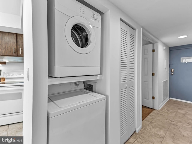 10900 Coastal Hwy Unit 915, Ocean City, MD 21842 - washroom with stacked washer / drying machine, baseboards, and light tile patterned floors