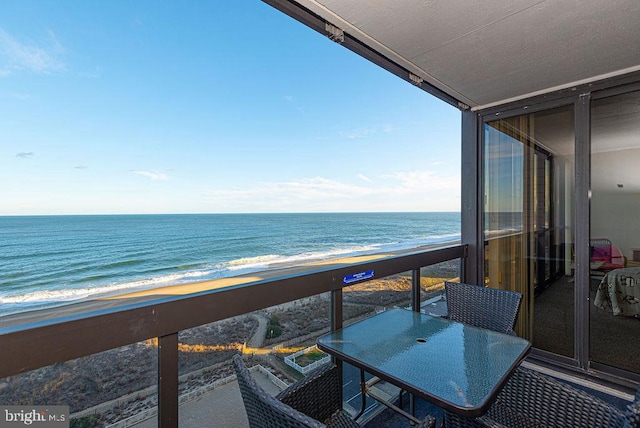 balcony with a water view and a beach view