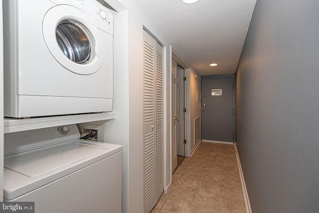 washroom with stacked washer and dryer