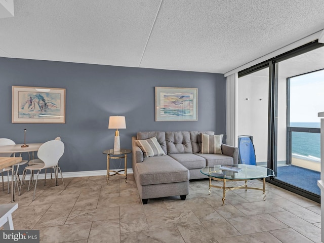 10900 Coastal Hwy Unit 915, Ocean City, MD 21842 - living area featuring floor to ceiling windows and a textured ceiling