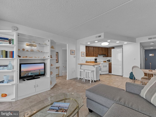 10900 Coastal Hwy Unit 915, Ocean City, MD 21842 - living room featuring a textured ceiling, recessed lighting, baseboards, and light tile patterned floors