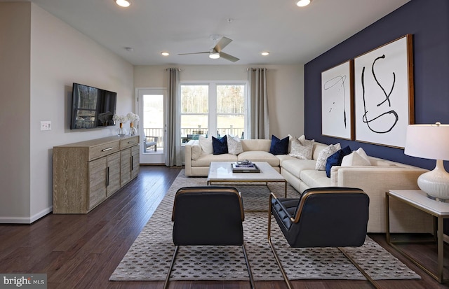 living room featuring dark hardwood / wood-style floors and ceiling fan