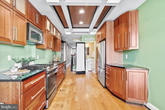 kitchen featuring coffered ceiling, stainless steel appliances, sink, beam ceiling, and light hardwood / wood-style floors