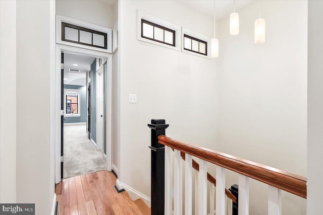 corridor with light hardwood / wood-style flooring