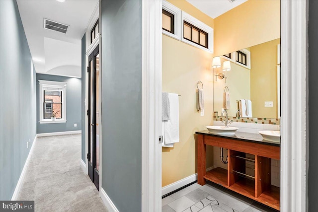 bathroom with vanity and decorative backsplash