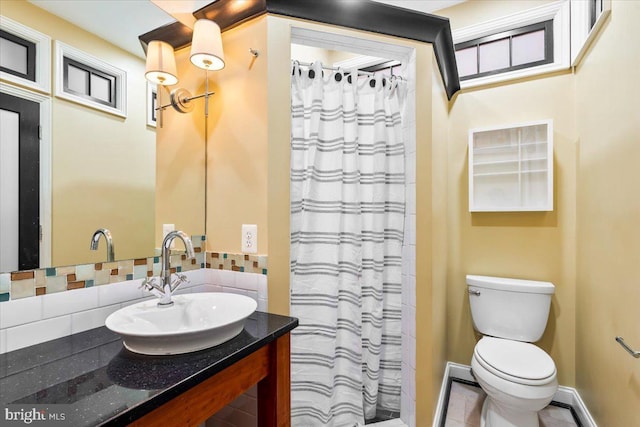 bathroom with vanity, a shower with curtain, backsplash, and toilet