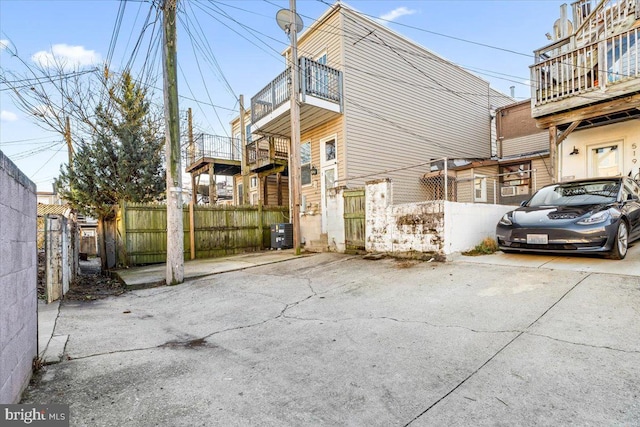 view of property exterior featuring a balcony and central AC