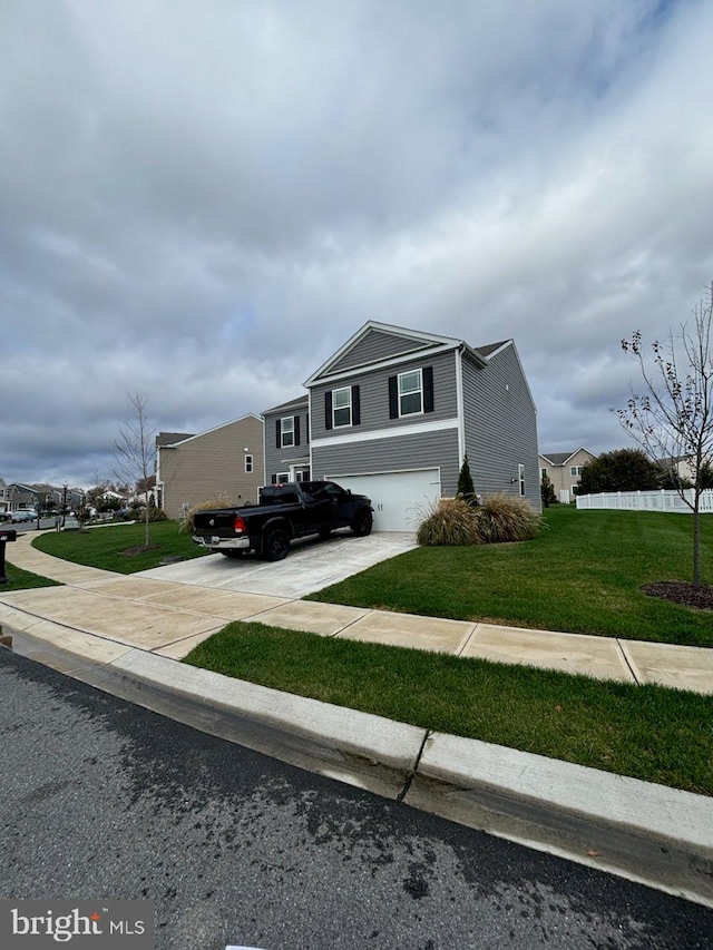 view of front of house with a garage and a front lawn