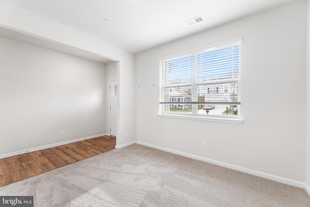 unfurnished room with hardwood / wood-style floors