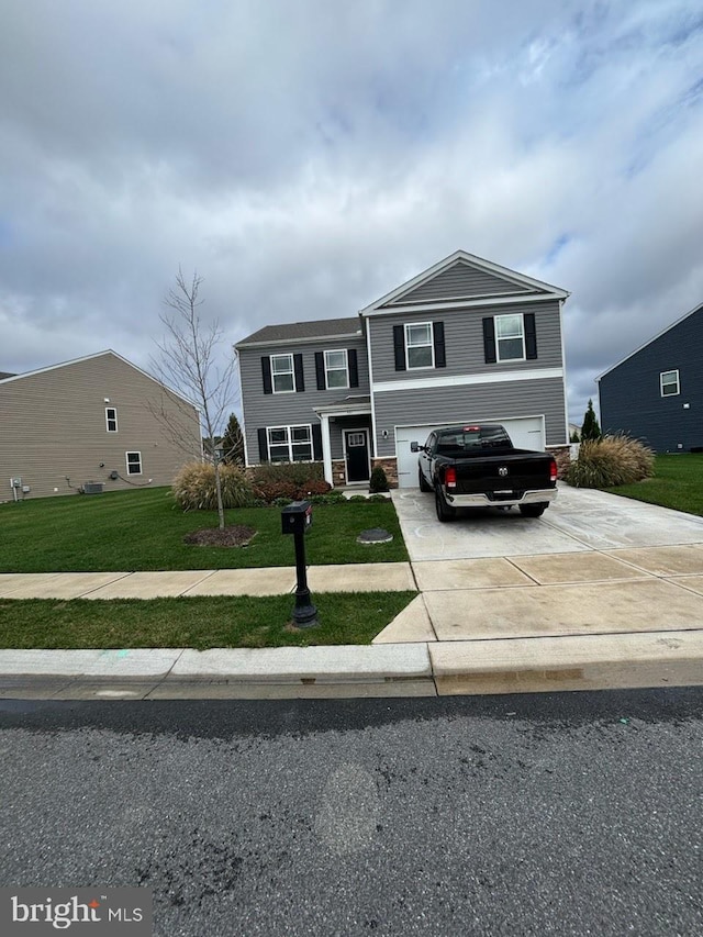 view of front of property with a front yard and a garage