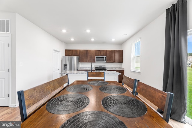 dining space with light hardwood / wood-style floors