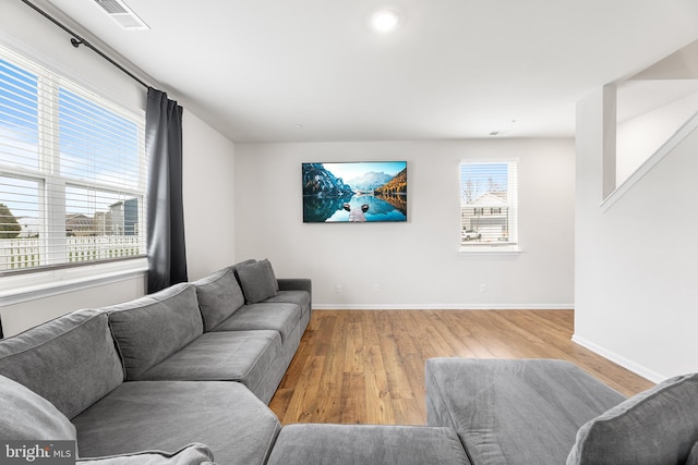 living room featuring light wood-type flooring and a wealth of natural light