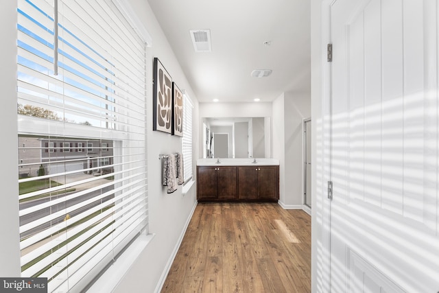 hallway with hardwood / wood-style floors