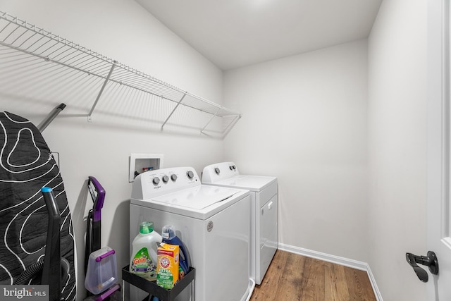 washroom featuring washer and clothes dryer and dark hardwood / wood-style floors