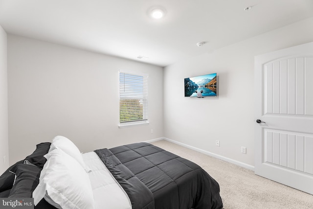 bedroom featuring light carpet