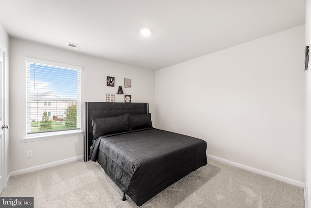 carpeted bedroom with multiple windows