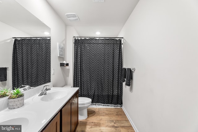 bathroom featuring a shower with curtain, toilet, vanity, and hardwood / wood-style flooring