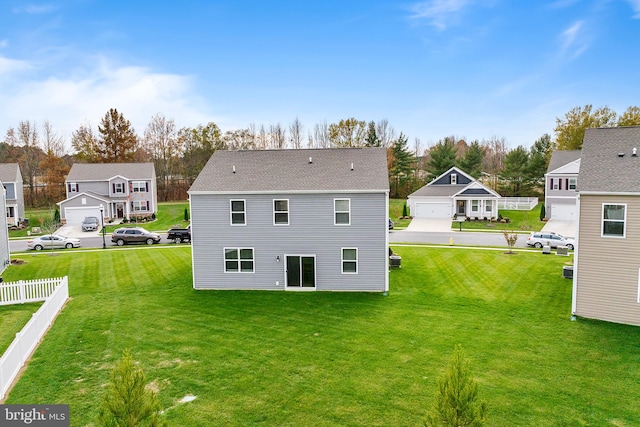 back of property featuring a lawn