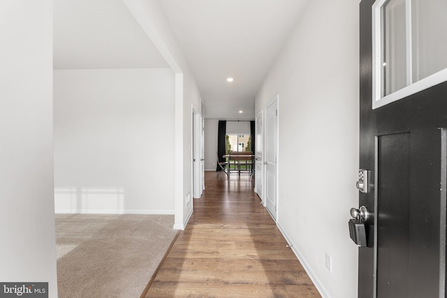 corridor with light hardwood / wood-style flooring