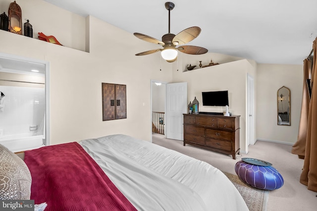 bedroom featuring light carpet, ensuite bathroom, high vaulted ceiling, and ceiling fan