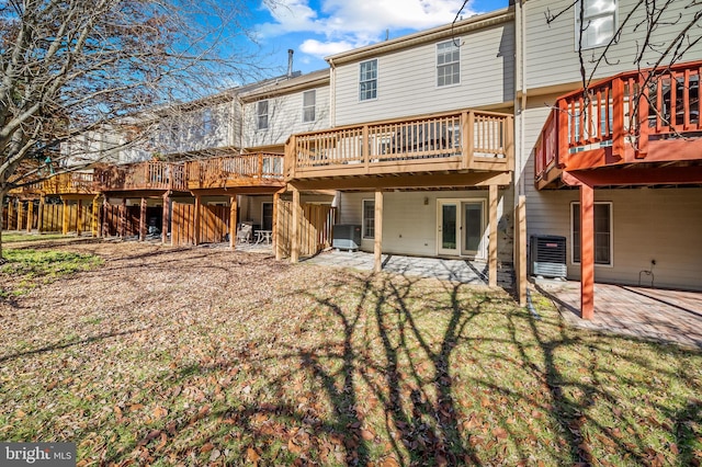 back of property with central air condition unit, a patio area, and a wooden deck