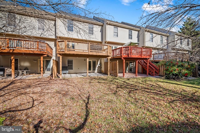 rear view of house featuring a patio area and a wooden deck