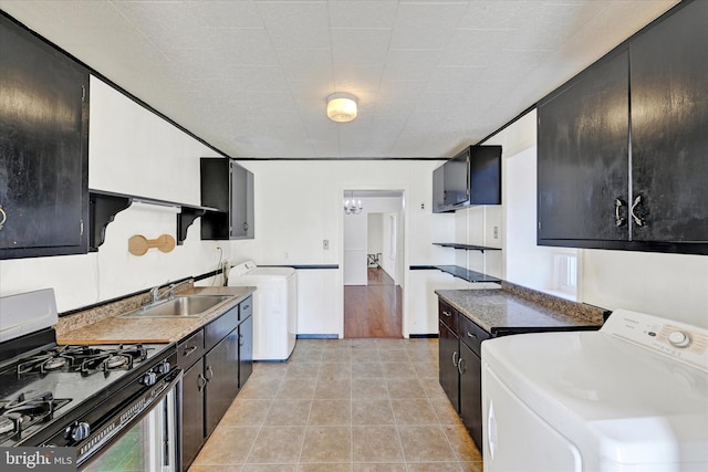 kitchen with washer / dryer, sink, and black gas range oven