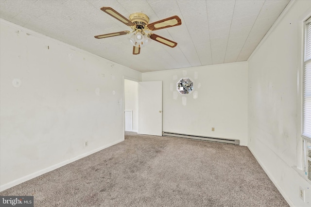 empty room featuring ceiling fan, a healthy amount of sunlight, carpet flooring, and a baseboard heating unit