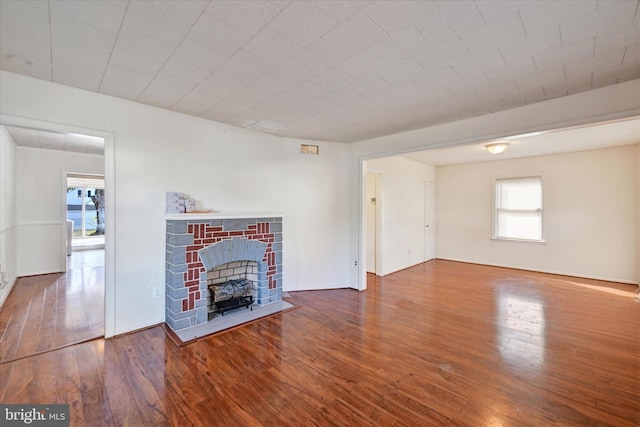 unfurnished living room with a fireplace and wood-type flooring